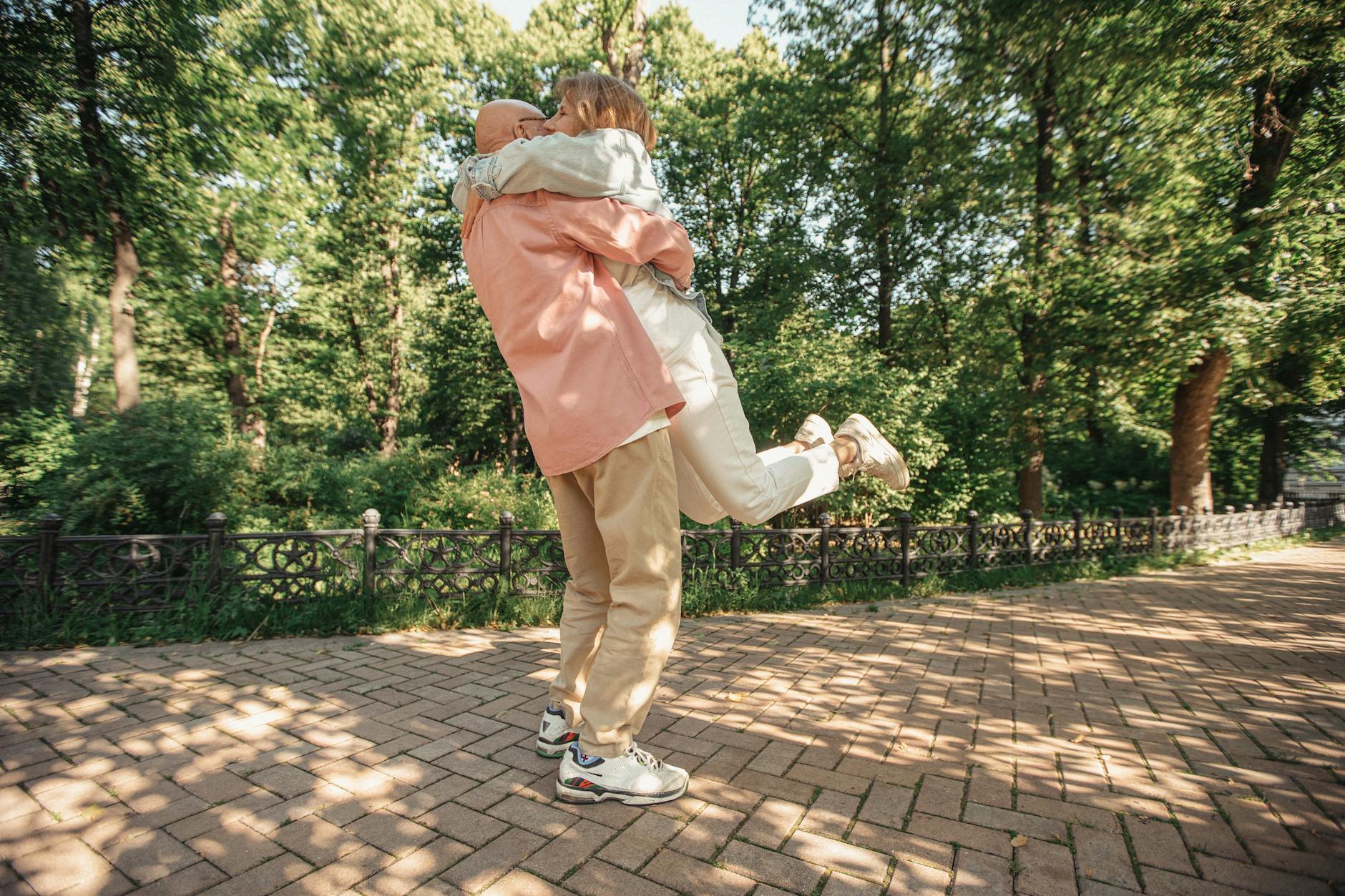bald man carrying the woman